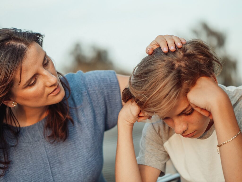 A mother consoling her son.