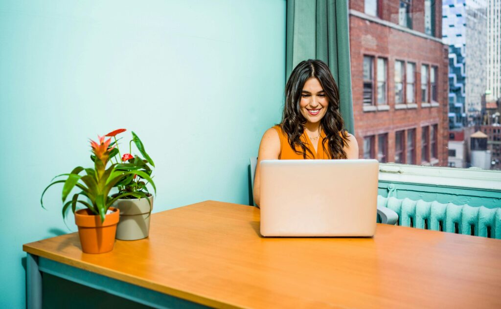 Woman smiling at a computer