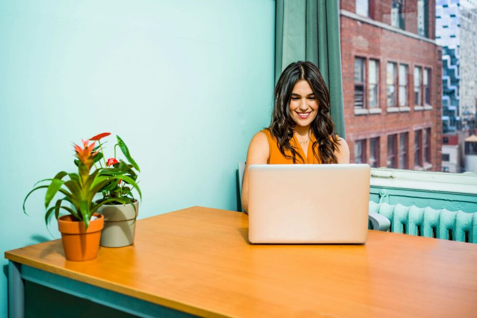 woman smiling at a computer